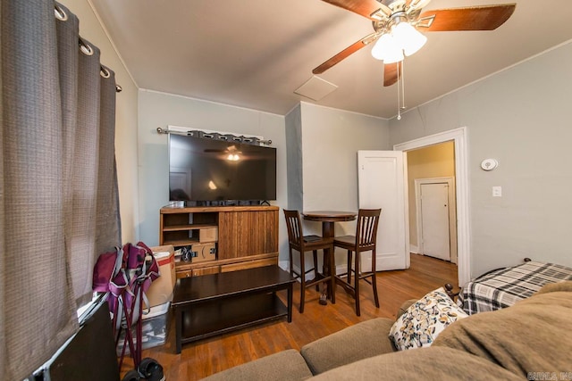 living room featuring wood-type flooring and ceiling fan