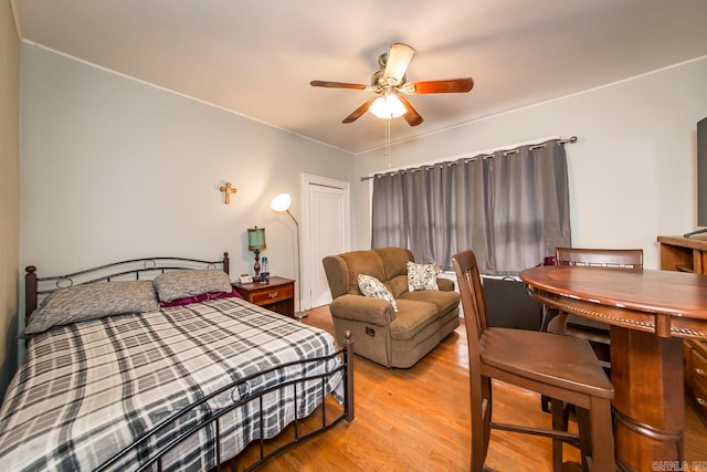 bedroom with ceiling fan and light wood-type flooring