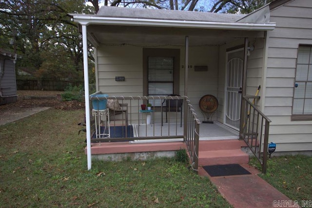 entrance to property with a lawn