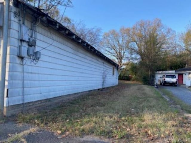 view of home's exterior with a lawn and a garage