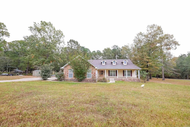 169 Whispering Oak Cir, El Dorado, AR 71730 - view of front of house with a front yard, a porch, and view of wooded area