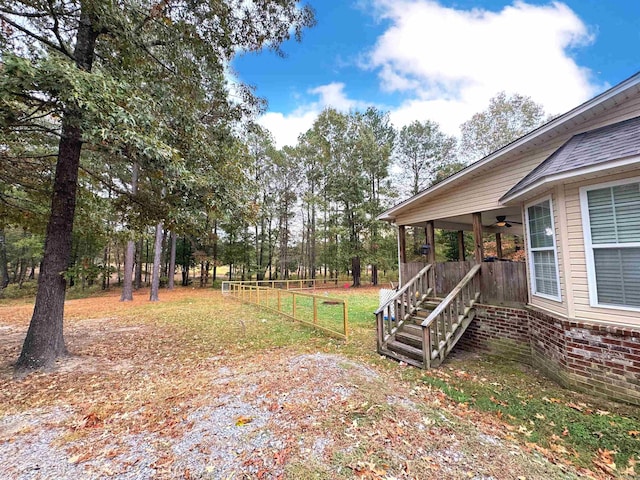 169 Whispering Oak Cir, El Dorado, AR 71730 - view of yard featuring ceiling fan, stairs, and fence