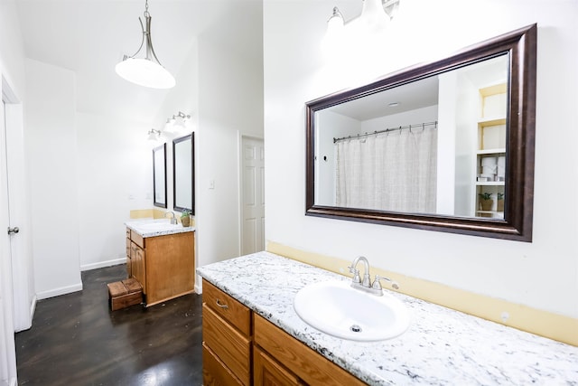 bathroom featuring vanity and a high ceiling