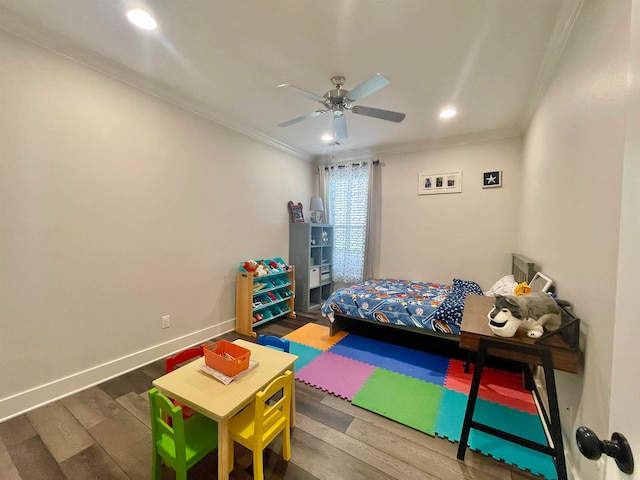 bedroom with dark hardwood / wood-style flooring, ceiling fan, and crown molding