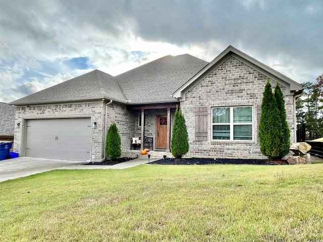 view of front of home featuring a front lawn and a garage