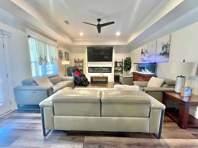 living room with hardwood / wood-style floors, ceiling fan, and crown molding