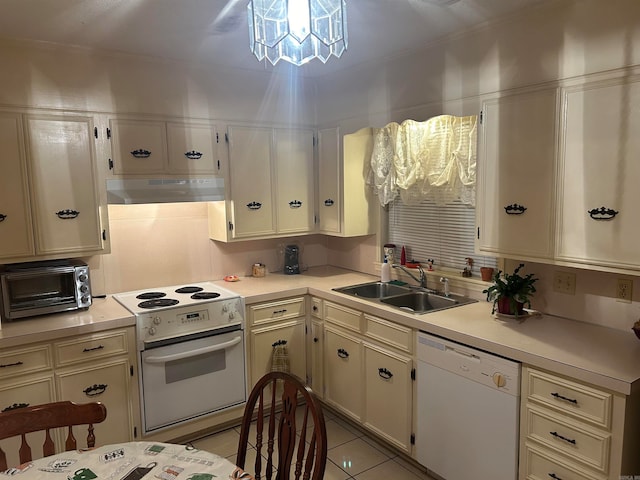 kitchen featuring crown molding, sink, white appliances, and light tile patterned floors