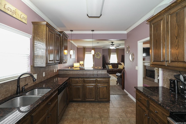 kitchen featuring a healthy amount of sunlight, dishwasher, and tasteful backsplash