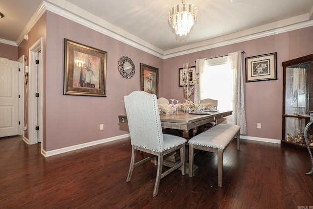 dining room with ornamental molding, dark hardwood / wood-style flooring, and a chandelier