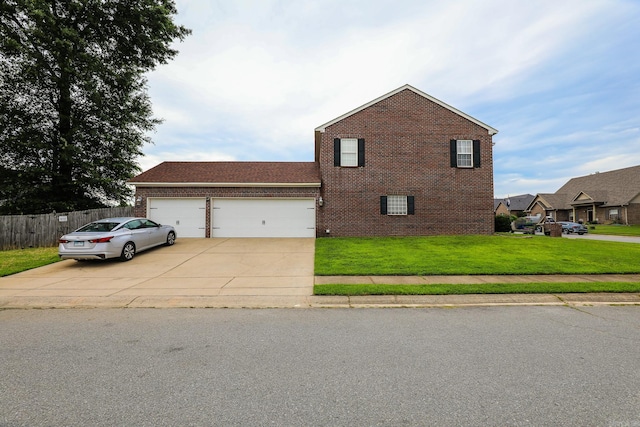 view of front of property featuring a front lawn and a garage