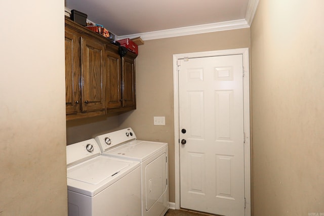 clothes washing area with ornamental molding, cabinets, and washer and dryer