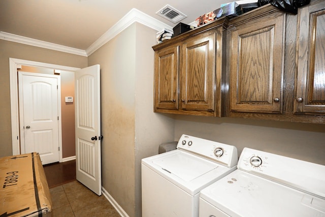 laundry area featuring tile patterned floors, cabinets, washer and dryer, and crown molding