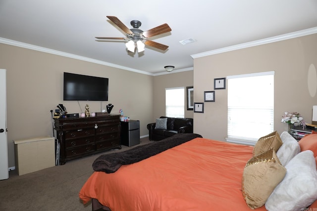 carpeted bedroom featuring ceiling fan and crown molding