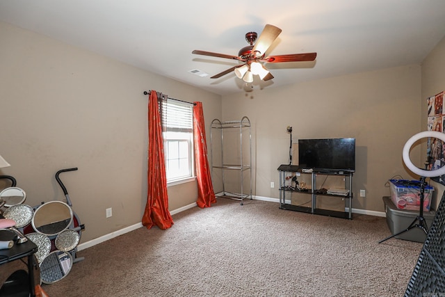 misc room with ceiling fan and carpet flooring