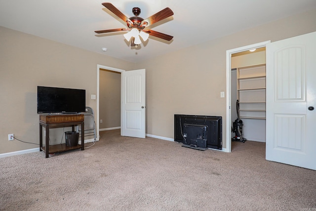 carpeted living room with ceiling fan