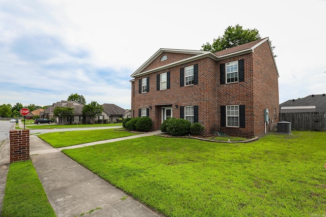 view of front of property featuring central AC unit and a front yard