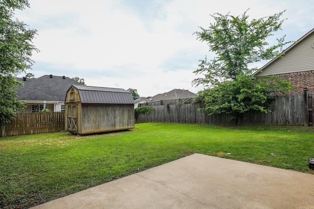 view of yard with a storage unit and a patio