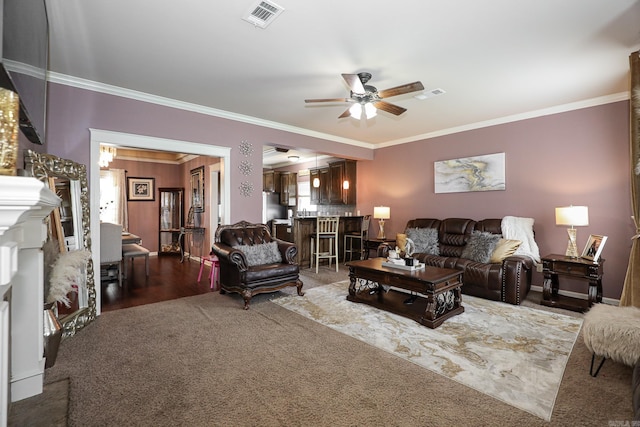 living room with ceiling fan, hardwood / wood-style floors, and ornamental molding