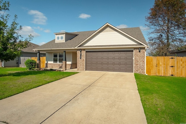 view of front of home with a front lawn and a garage