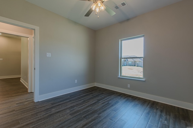 empty room featuring dark wood-type flooring and ceiling fan