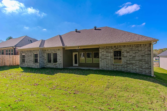 back of house featuring a patio area, a lawn, and ceiling fan