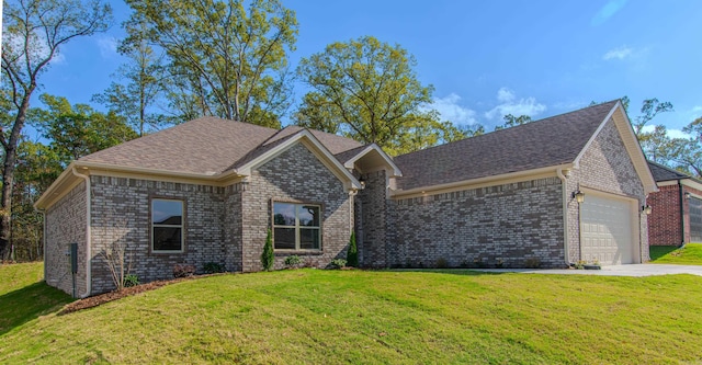 view of front of home with a garage and a front lawn