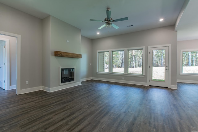 unfurnished living room with ceiling fan and dark hardwood / wood-style flooring