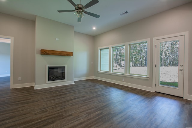 unfurnished living room featuring dark hardwood / wood-style flooring and ceiling fan