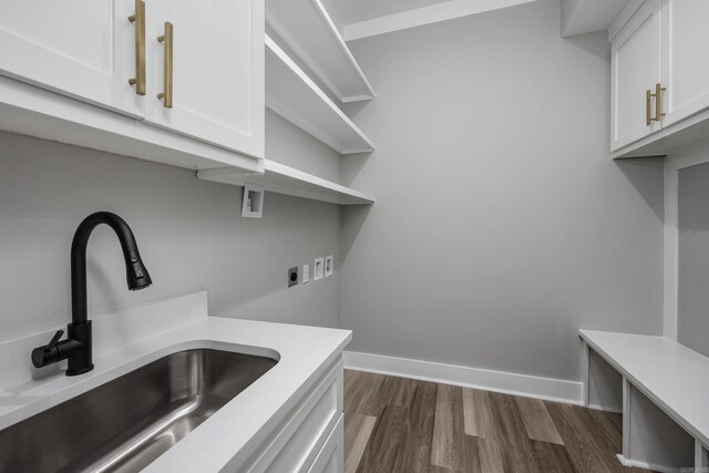 clothes washing area featuring cabinets, sink, electric dryer hookup, dark wood-type flooring, and hookup for a washing machine