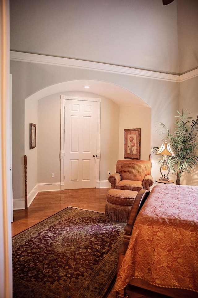 bedroom featuring hardwood / wood-style floors and ornamental molding