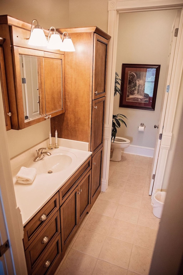 bathroom featuring vanity, tile patterned floors, and toilet