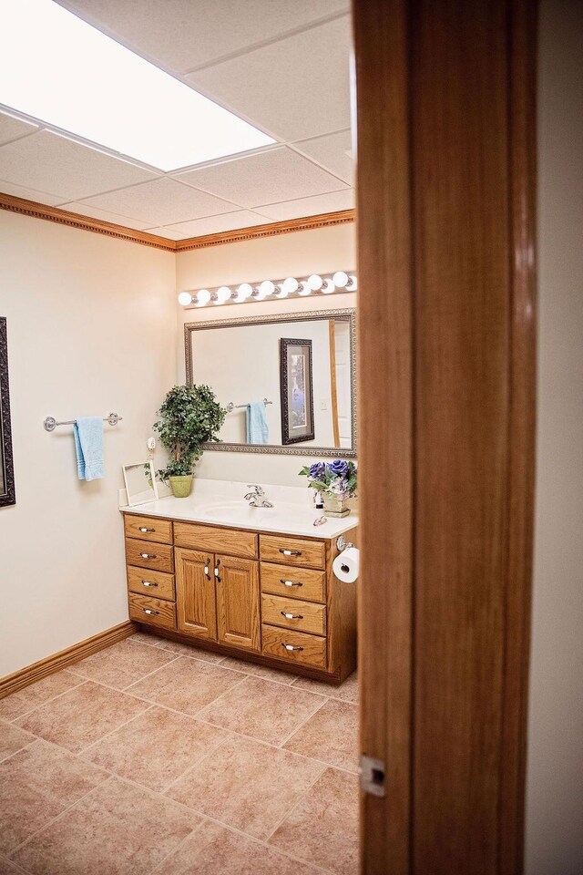 bathroom with a drop ceiling and vanity