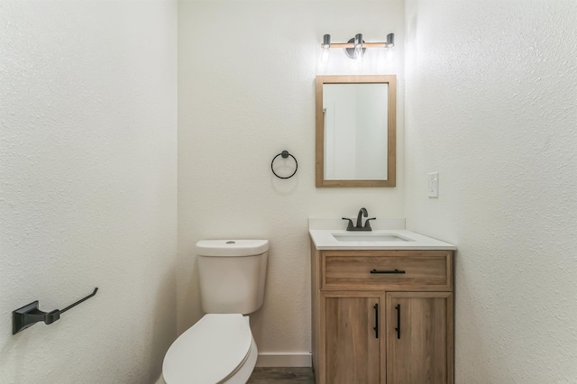 bathroom with toilet and vanity