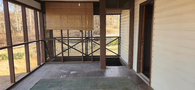 unfurnished sunroom featuring a wealth of natural light