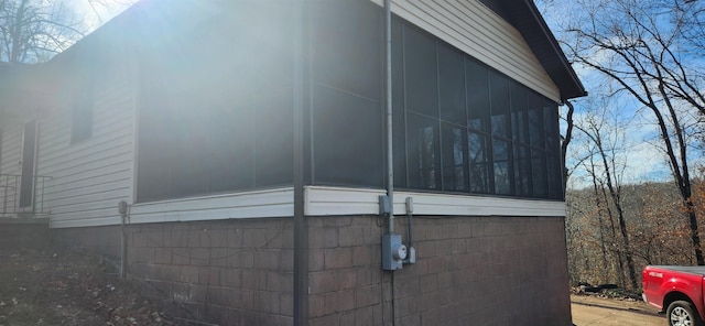 view of side of home featuring a sunroom