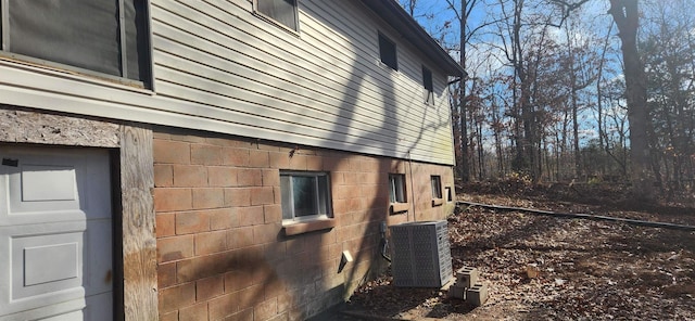 view of side of home with central AC