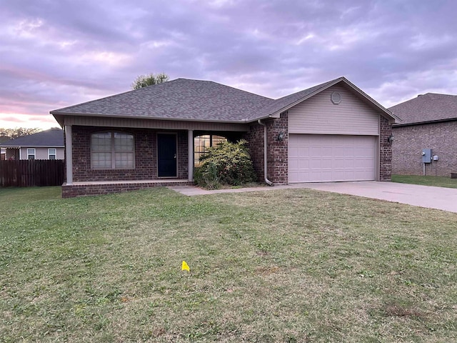 ranch-style home featuring a garage and a front yard