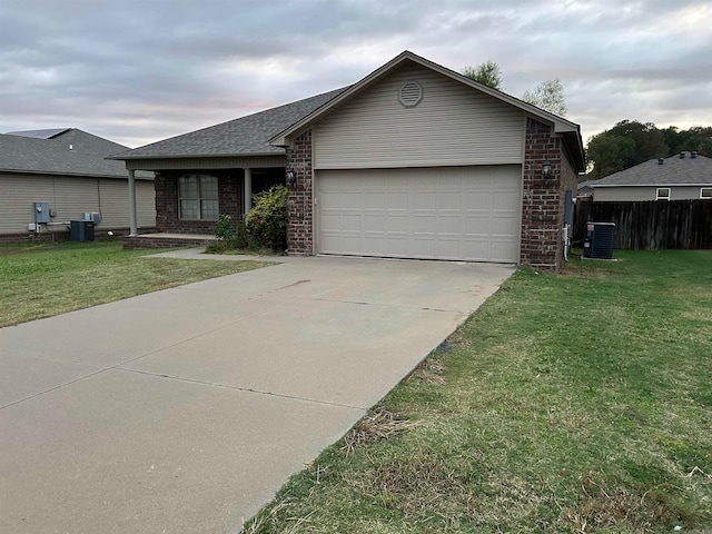 ranch-style house with a garage and a front yard