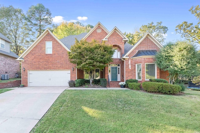 view of front of house with a garage, a trampoline, a front lawn, and central AC