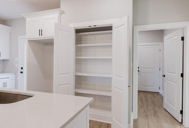 interior space featuring white cabinets and light wood-type flooring