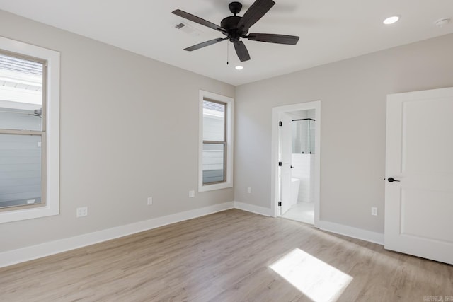 unfurnished bedroom featuring light hardwood / wood-style floors, ceiling fan, and ensuite bath