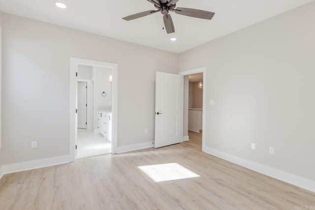 unfurnished bedroom with ensuite bathroom, light wood-type flooring, and ceiling fan