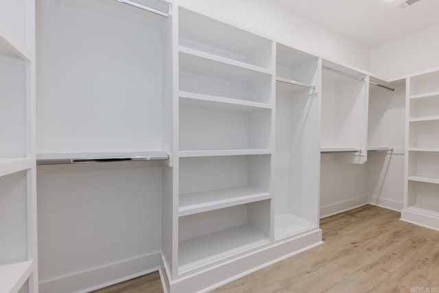 spacious closet featuring light hardwood / wood-style floors