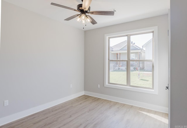 unfurnished room featuring light wood-type flooring, a wealth of natural light, and ceiling fan