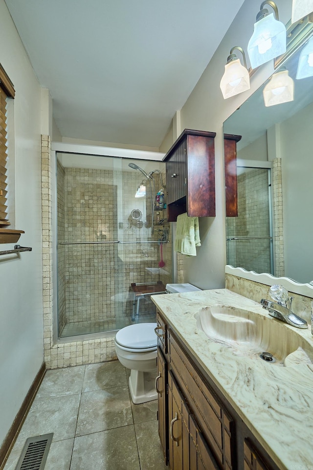 bathroom featuring walk in shower, tile patterned floors, vanity, and toilet