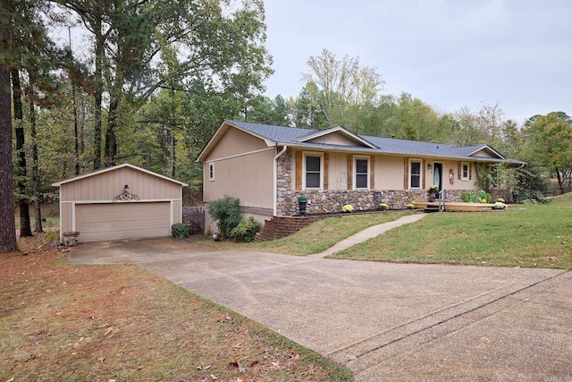 ranch-style home featuring an outbuilding, a garage, and a front yard