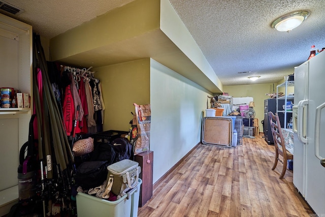 interior space with light hardwood / wood-style flooring and a textured ceiling