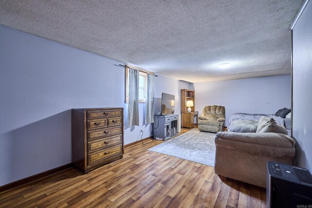 living room with hardwood / wood-style floors and a textured ceiling