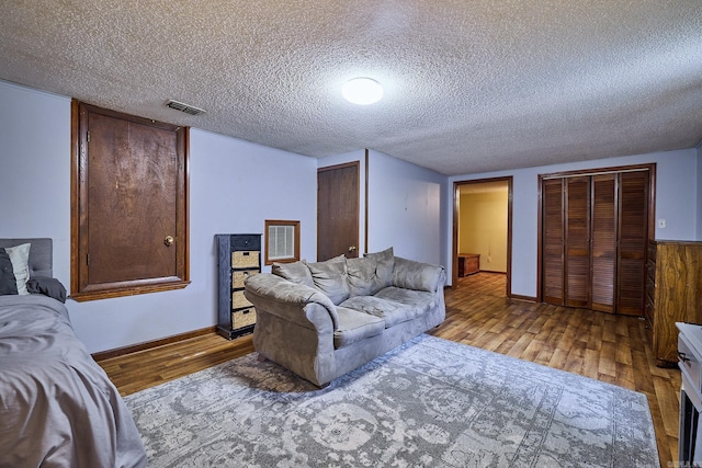 living room featuring light hardwood / wood-style flooring and a textured ceiling