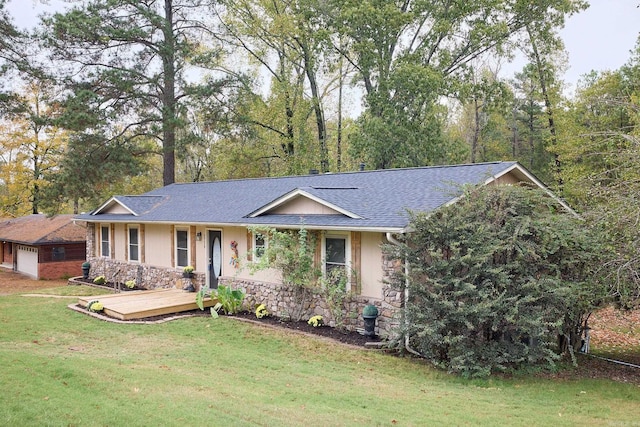 ranch-style home featuring a deck and a front yard